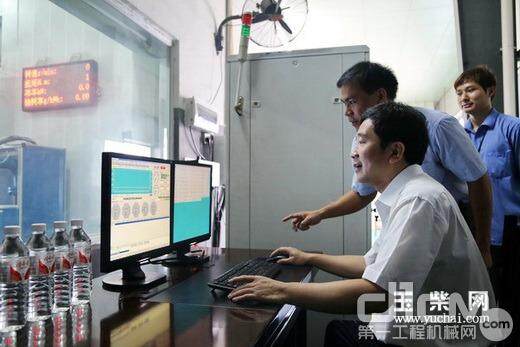 Yan Ping operates the control system to ignite and start the engine.